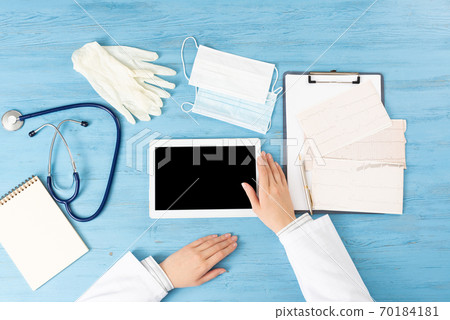 Top view of doctor hands with tablet computer Top view of doctor hands with tablet computer 70184181