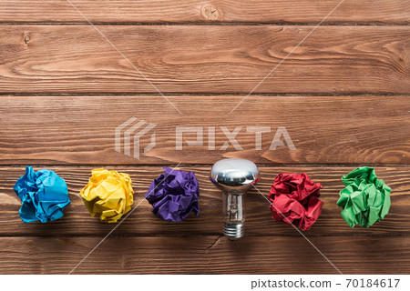 Ideological concept with wastepaper light bulb on wooden table 70184617