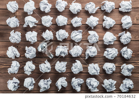 Ideological concept with wastepaper light bulb on wooden table 70184632