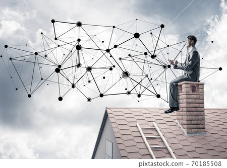Man on roof with smartphone and concept of social connection 70185508