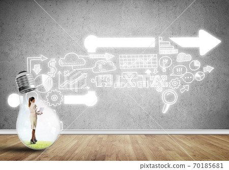Businesswoman trapped in bulb Businesswoman trapped in bulb 70185681