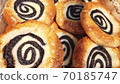 Sour cream buns swirl with poppy seeds closeup background. Sweet pastry. Apetite buns. Smetannik cookies famous in Russian . 70185747