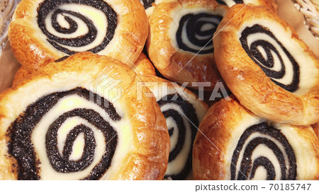 Sour cream buns swirl with poppy seeds closeup background. Sweet pastry. Apetite buns. Smetannik cookies famous in Russian . Sour cream buns swirl with poppy seeds closeup background. Sweet pastry. Apetite buns. Smetannik cookies famous in Russian . 70185747