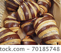 French croissants chocolate bagels are in the basket view closeup background. Bakery products. Sweet pastry. Apetite buns. French breakfast. 70185748