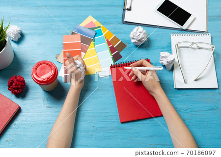 Interior designer choosing colors from swatches Interior designer choosing colors from swatches 70186097
