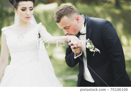 Caucasian happy romantic young couple celebrating their marriage. Outdoor Caucasian happy romantic young couple celebrating their marriage. Outdoor 70186106