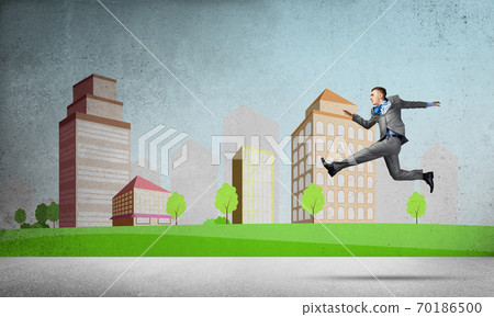 Businessman jumping high 70186500