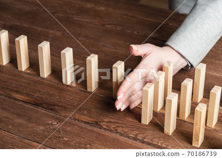 Business woman block domino effect. 70186739
