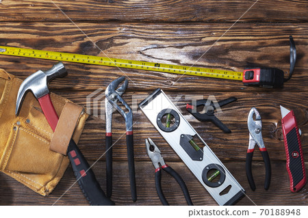 Close up tools on a wooden background. Close up tools on a wooden background. 70188948