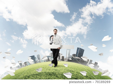 Conceptual image of businessman pointing aside Conceptual image of businessman pointing aside 70189269