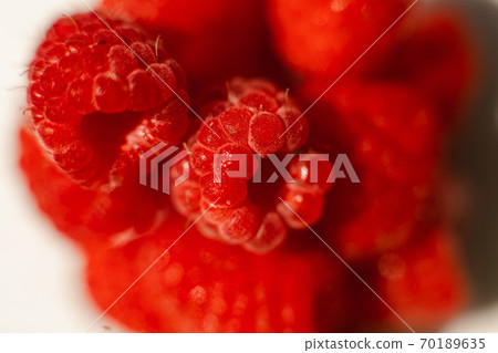 Beautiful raspberries in triangle shape lies Beautiful raspberries in triangle shape lies 70189635