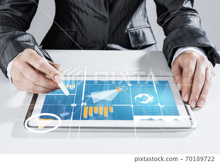 Media technologies for business as concept with woman working on tablet Media technologies for business as concept with woman working on tablet 70189722