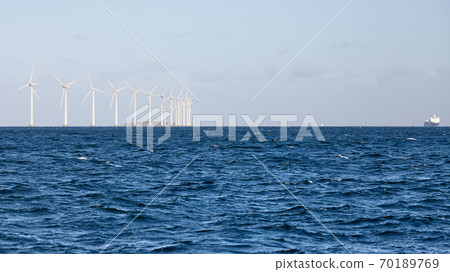 Panoramic view of offshore windmill farm. 70189769