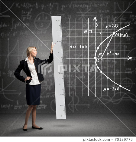 Young mathematics teacher holding big ruler 70189773