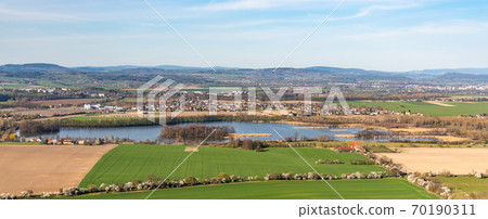 Agricultural landscape with pond and spring fields Agricultural landscape with pond and spring fields 70190311