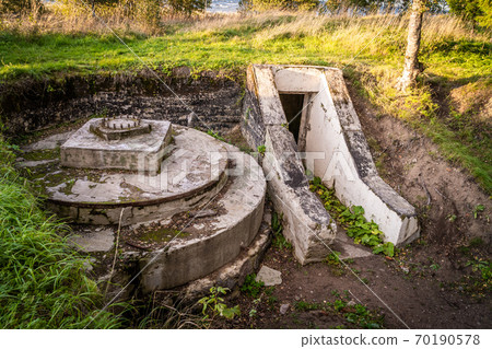 Russia. Leningrad region. Grey horse Fort. The entrance to the defenses of battery 332 and the preserved carriage for Vickers guns. Russia. Leningrad region. Grey horse Fort. The entrance to the defenses of battery 332 and the preserved carriage for Vickers guns. 70190578