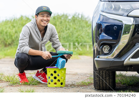 A man who enjoys car washing with a smile A man who enjoys car washing with a smile 70194240