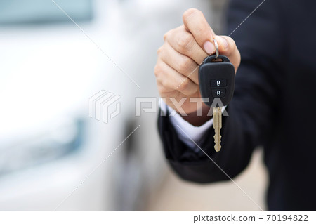 Car key, businessman handing exchange over give to the other man on showroom Car key, businessman handing exchange over give to the other man on showroom 70194822