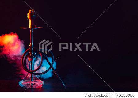 glass hookah shisha with a metal bowl on the table on a black background with smoke glass hookah shisha with a metal bowl on the table on a black background with smoke 70196096