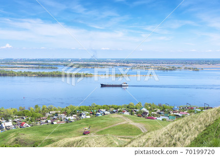 view from the cliff to the Volga river, suburban buildings, coastline, tanker going along the river view from the cliff to the Volga river, suburban buildings, coastline, tanker going along the river 70199720