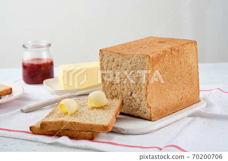 Butter curl on toast bread. Healthy breakfast with bran bread toast, butter and jam. 70200706