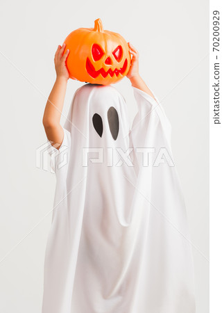 child with white dressed costume halloween ghost scary he holding orange pumpkin ghost on hand child with white dressed costume halloween ghost scary he holding orange pumpkin ghost on hand 70200929