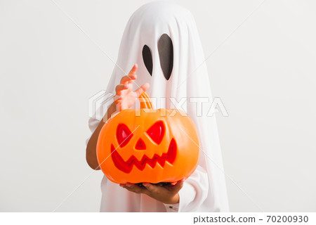 child with white dressed costume halloween ghost scary he holding orange pumpkin ghost on hand child with white dressed costume halloween ghost scary he holding orange pumpkin ghost on hand 70200930