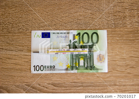 Thermometer for temperature measurement lies on the euro. The euro is on the verge of falling ill with the economic crisis. 70201017