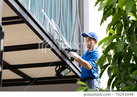 Asian workers technicians man installing solar photovoltaic panels for LED lamps. Asian workers technicians man installing solar photovoltaic panels for LED lamps. 70201046