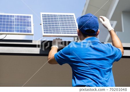 Asian workers technicians man installing solar photovoltaic panels for LED lamps. Asian workers technicians man installing solar photovoltaic panels for LED lamps. 70201048