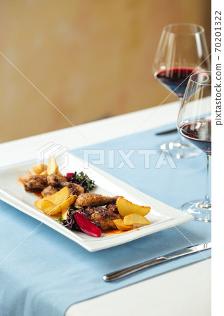 Closeup on grilled chicken with potatoes and wine Closeup on grilled chicken with potatoes and wine 70201322