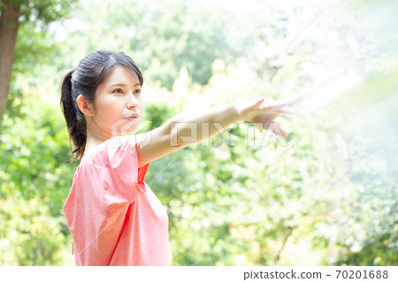 Young woman doing yoga poses in the fresh green Photo cooperation: Santome Konjyamura Young woman doing yoga poses in the fresh green Photo cooperation: Santome Konjyamura 70201688