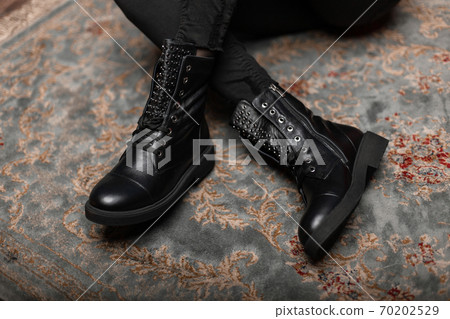 Fashionable young woman is sitting on a vintage 70202529