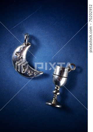 The Moon and the Cup, symbols of a pagan witchcraft ritual, a flatlay The Moon and the Cup, symbols of a pagan witchcraft ritual, a flatlay 70202952
