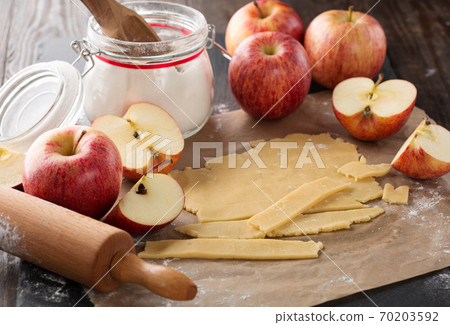 Cooking baking concept. Making rustic American style apple pie, view on table with ingredients. 70203592