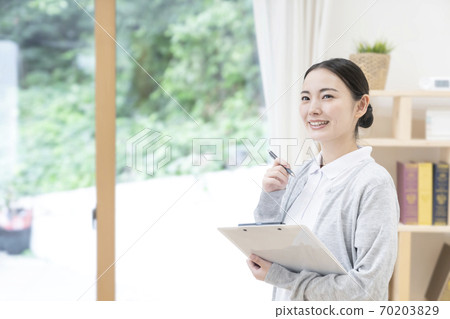 Young female caregiver 70203829