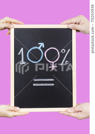 Hands holding a board with the 100% equal symbol on a pink background Hands holding a board with the 100% equal symbol on a pink background 70203936