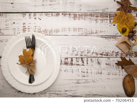 Autumn tableware on wooden background with leaves  70206453