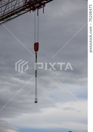 part of a construction crane against a blue sky with clouds, evening part of a construction crane against a blue sky with clouds, evening 70206475