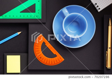 office supplies and empty cup of coffee at black background office supplies and empty cup of coffee at black background 70207286