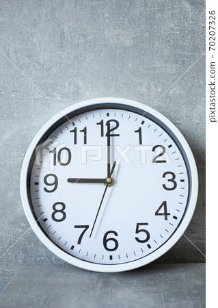 wall clock at grey shelf with abstract background wall clock at grey shelf with abstract background 70207326