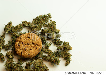 Oat cannabis cookie with THC on white background with copy space. Marijuana buds top view 70208229