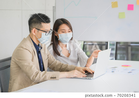 businessman and businesswoman wears face mask discuss business project businessman and businesswoman wears face mask discuss business project 70208341