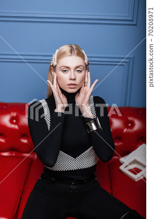 Young attractive woman posing in studio in black Young attractive woman posing in studio in black 70208971