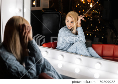 Pretty young woman in a fashion knitted suit is 70209022