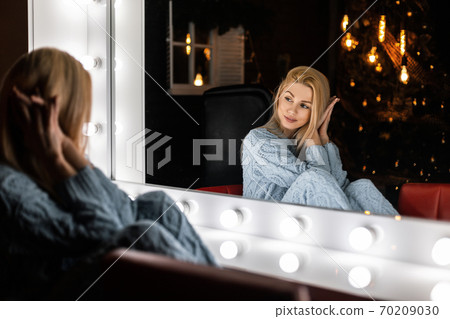 Pretty glamour young woman with a blond hair sits Pretty glamour young woman with a blond hair sits 70209030