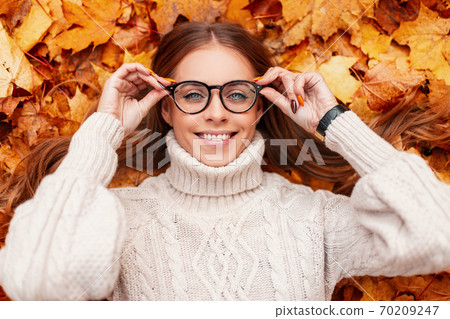 Funny joyful young hipster woman in a warm knitted Funny joyful young hipster woman in a warm knitted 70209247