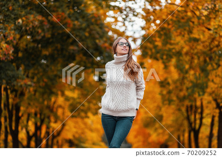 Joyful young woman model in a white knitted 70209252