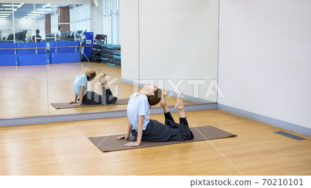 Young woman doing yoga image stretching Young woman doing yoga image stretching 70210101