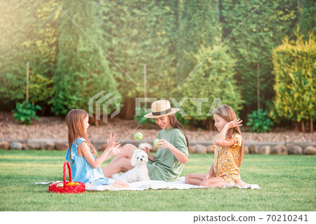 Happy mother and little daughers relax in suumer Happy mother and little daughers relax in suumer 70210241